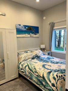 a bedroom with a bed and a window at The Cottage - A Private Oceanfront Dream! in East Sooke