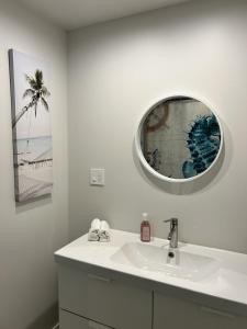 a bathroom with a sink and a mirror at The Cottage - A Private Oceanfront Dream! in East Sooke
