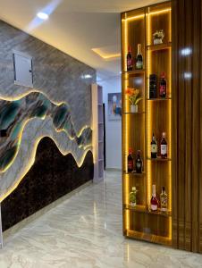 a lobby with a wall with bottles of alcohol at Deluxe Haven Apartment in Lekki