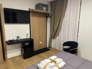 a hotel room with a bed and a television at Royal Residence in Santa Maria Capua Vetere