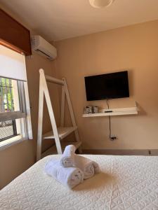 ポサーダスにあるDepartamento Temporario GPのタオルが敷かれたベッドのある寝室