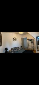 a bedroom with a bed and a ladder in it at Chez Nadine in Saint-Georges-de-Reintembault