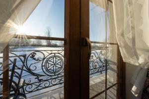 a window with a view of a balcony at Willa Giergonia in Bukowina Tatrzańska