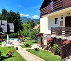 a house with a garden and a patio at Plitvice Lower Lakes Rooms in Plitvica Selo +48 photos