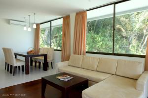 a living room with a couch and a table at Tiara Bunga Hotel & Villa in Balige
