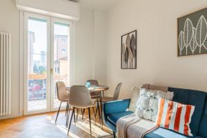 a living room with a couch and a table at Oasis Apartment in Bologna