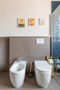 a bathroom with a white toilet and a sink at Oasis Apartment in Bologna +25 photos