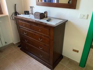 a wooden dresser in a bathroom with a mirror at La casa nella Pinetina in Alfedena +53 photos