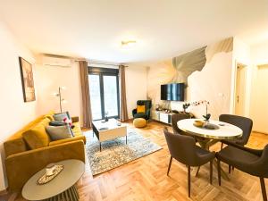 a living room with a couch and a table at NEPTUN Apartments in Vrnjačka Banja
