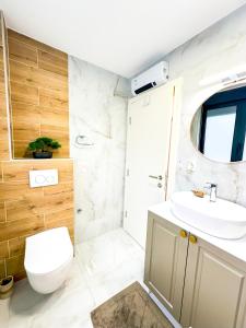 a bathroom with a toilet and a sink at NEPTUN Apartments in Vrnjačka Banja +32 photos