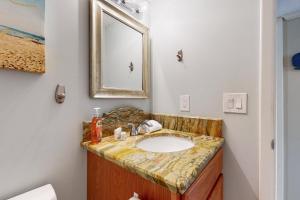 a bathroom with a sink and a mirror at HB289 Feel the Burn in Holden Beach