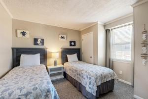 a bedroom with two beds and a window at HB289 Feel the Burn in Holden Beach