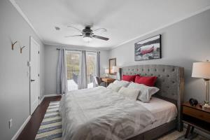 a bedroom with a large bed with red pillows at Serene Lakeside Retreat with Hot Tub Near Gunstock in Gilford