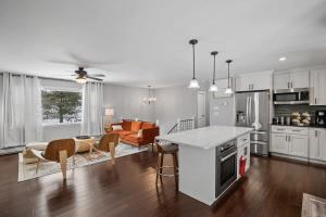 a kitchen and living room with a table and chairs at Serene Lakeside Retreat with Hot Tub Near Gunstock in Gilford +39 photos