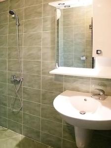 a bathroom with a sink and a shower at Motel Maritsa in Dimitrovgrad