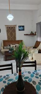 a living room with a table with a vase on it at La Casita del Mar in Mar del Tuyú