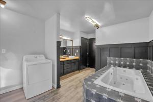 a large bathroom with a tub and a sink at Lakefront Movie Theater, Hot Tub, Arcade, Boats in Gouldsboro +81 photos