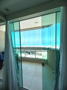 a bathroom with a shower with a view of the ocean at Apartamento Luxo Vista Mar Andrei Noriller in Arraial do Cabo +37 photos