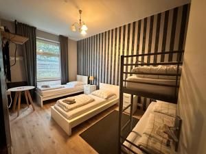 a room with two bunk beds and a window at Adam's Hostel - Self Check-In & Only Private Rooms in Düsseldorf