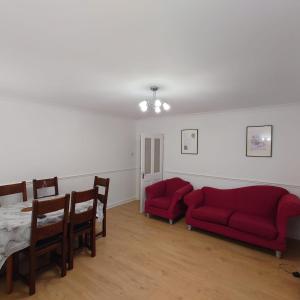 福尔柯克RF-Entire House-Central Scotland-Falkirk, Self-Check-in , Pet-friendly and with Parking的客厅里有两张红色沙发和一张桌子