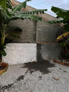 a brick building with a door on the side of it at Studio Morro das Pedras Floripa com Jacuzzi in Florianópolis +3 photos