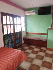 a bedroom with a bed and a tv on the wall at lodelrafa in San Lorenzo