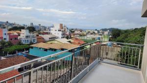 a balcony with a view of a city at Pousada Águas de 4 Ilhas in Bombinhas