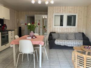 a kitchen and living room with a table and a couch at Villa La PROVENCE in Hyères