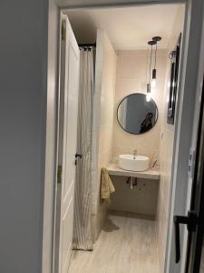 a bathroom with a sink and a mirror at Senderos del Mar in Monte Hermoso +12 photos