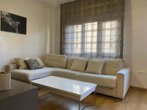 ein Wohnzimmer mit Sofa und Tisch in der Unterkunft Apartamento "MOY" Sierra Nevada Parking gratuito in Sierra Nevada