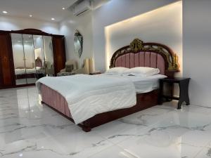 a bedroom with a large bed and a marble floor at توتn in Hail