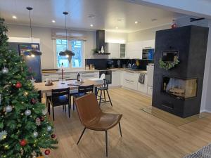 a kitchen with a christmas tree and a dining room at Arctic Lakeside Villa in Kemijärvi