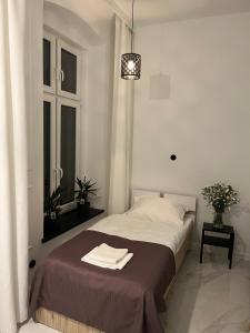 a bedroom with a bed with towels on it at Jeżyce centrum in Poznań +7 photos