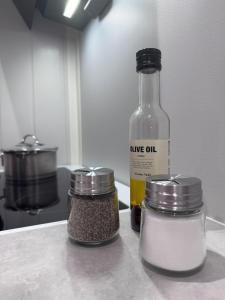 a bottle of oil sitting on a counter with spices at Sauna Apartment in Tromsø