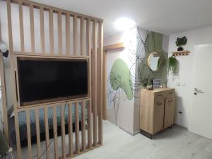 a living room with a flat screen tv in a room at Studio apartman Čolić - Kupres in Kupres