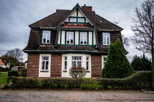 a red brick house with a gambrel roof at 4 Zimmer hochwertig saniertes Cityapartment ruhig gelegen in Brunsbüttel