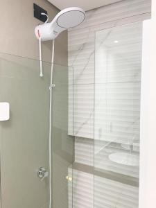 a shower with a shower head in a bathroom at Espaço aconchegante próximo a UFSC in Florianópolis +22 photos
