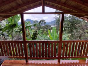 a view from the inside of a screened in porch with a window at Cabaña octaluz in Jardin