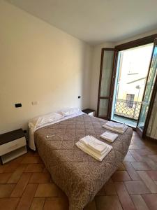 a bedroom with a bed with towels on it at Aselli Palace in Cremona
