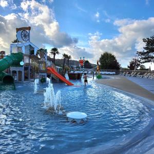 a water park with a water slide and a water fountain at Mobile Home XL Camping 5 étoiles in Houlgate