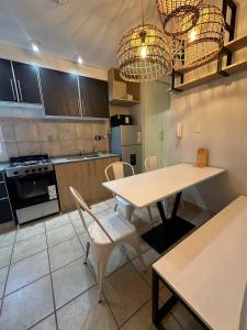 a kitchen with a table and chairs in a room at Departamento Junín 4 Bitcoins House in Corrientes +5 photos