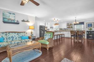 a living room with a couch and a table at Blue Fish Shack by Oak Island Accommodations in Oak Island