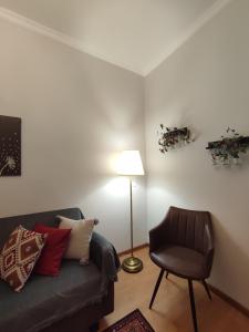 a living room with a couch and a lamp and a chair at Pepper House Edessa in Edessa