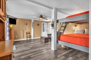 a bedroom with a bunk bed and a living room at Blue Fish Shack by Oak Island Accommodations in Oak Island