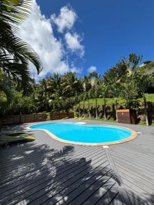 a swimming pool in the middle of a patio at Le Fare Tianee, Résidence Légends, BEST VIEW in Moorea