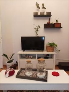 a living room with a tv on a table at Pepper House Edessa in Edessa +44 photos