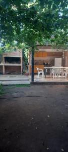 a patio with chairs and a table and a piano at Alojamiento Nonino in Villa Cura Brochero