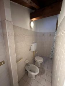 a bathroom with a toilet and a bidet at Dante 13 Flat in Cremona +12 photos