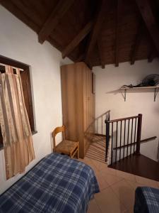 a bedroom with a bed and a stair case at Dante 13 Flat in Cremona