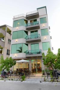 a tall building with tables and chairs in front of it at Season Holidays at Hulhumale with Transfer in Hulhumale